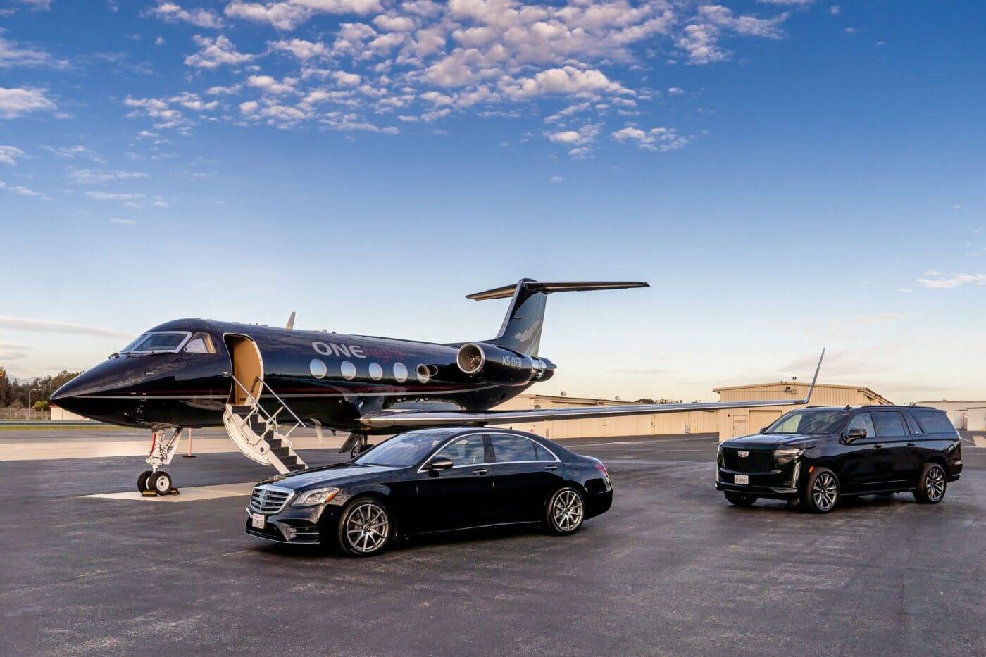 Private jet with chauffeured Mercedes S-Class and Cadillac Escalade on the tarmac